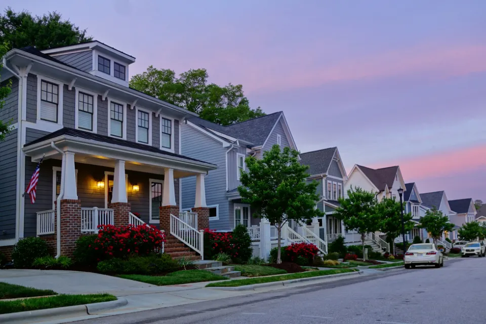 View of houses on small street in Raleigh, North Carolina against a sunset sky
